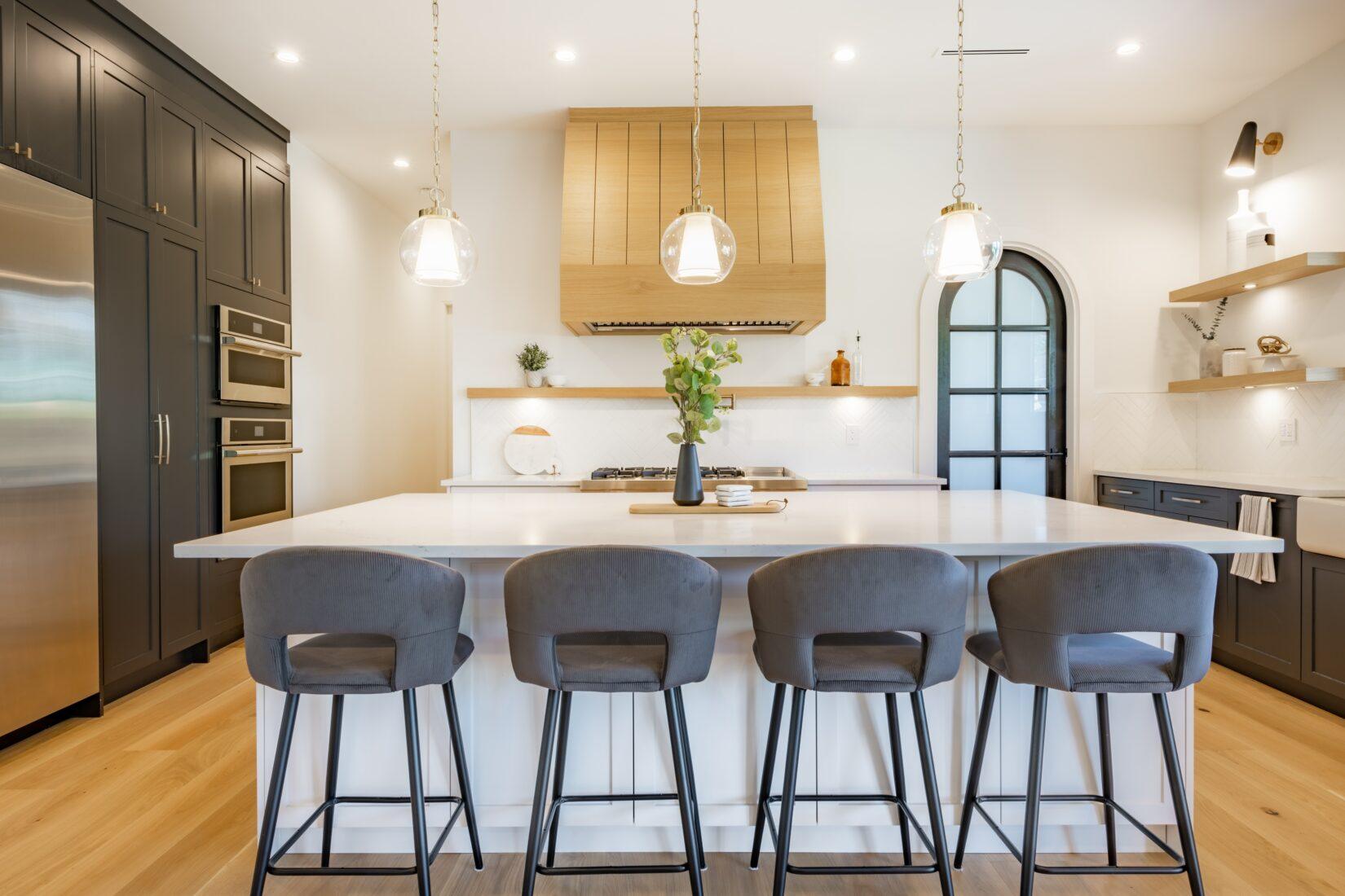 Custom home kitchen with island and dark cabinetry, Omaha