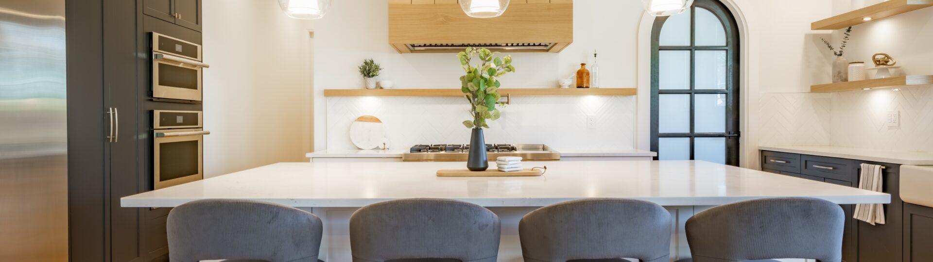 Contemporary kitchen with black cabinetry and center island in a custom-built Omaha home by Gottsch Construction
