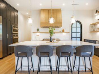 Contemporary kitchen with black cabinetry and center island in a custom-built Omaha home by Gottsch Construction