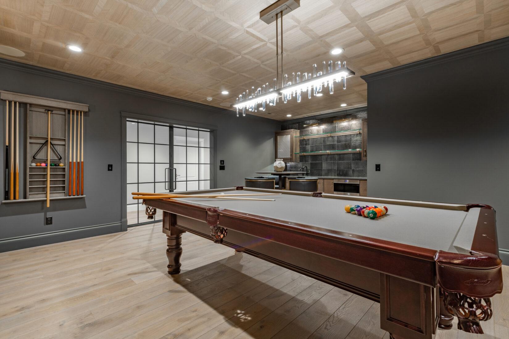 Finished basement rec room with pool table in Omaha home