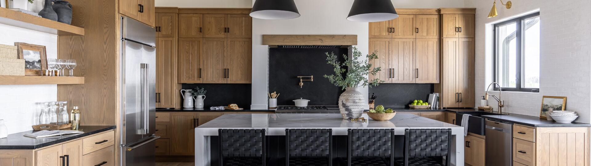 Whole home renovation in Omaha featuring a custom kitchen with vaulted ceilings, exposed wood beams, large island, and open-concept design