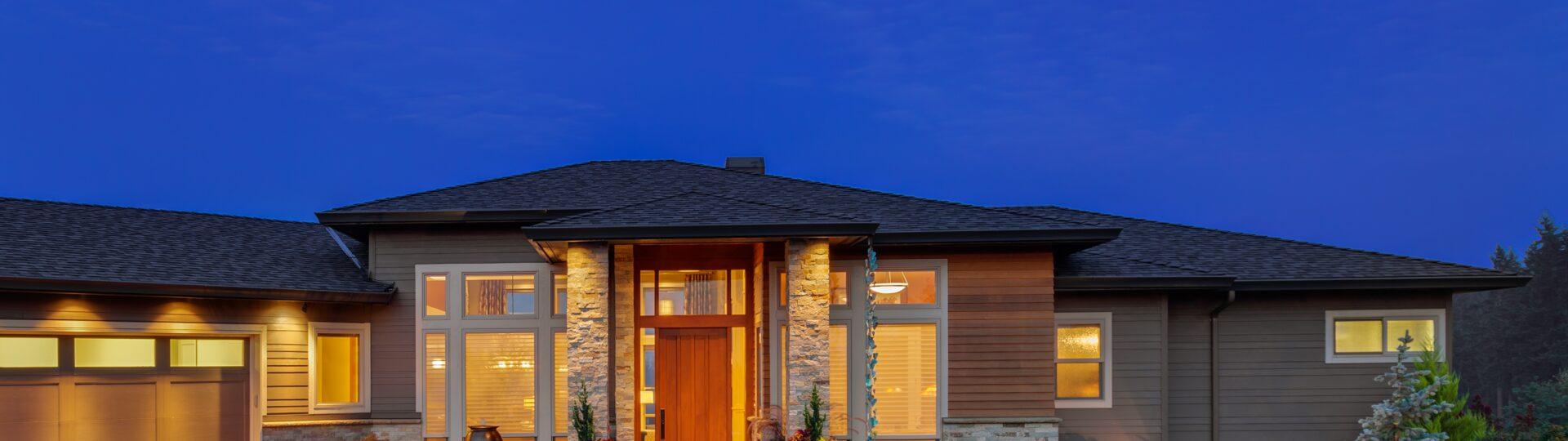 Modern custom ranch home exterior at dusk in Omaha, Nebraska