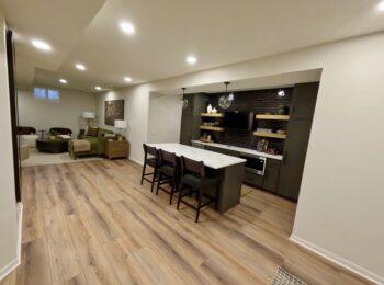 Finished basement with wet bar and open living area in Omaha